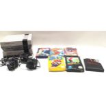 Nintendo entertainment systems x 2 with a few games and a couple of controllers.