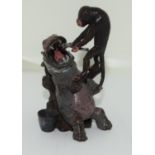 Bronze figure of a Monkey Dentist servicing a Hippo patient