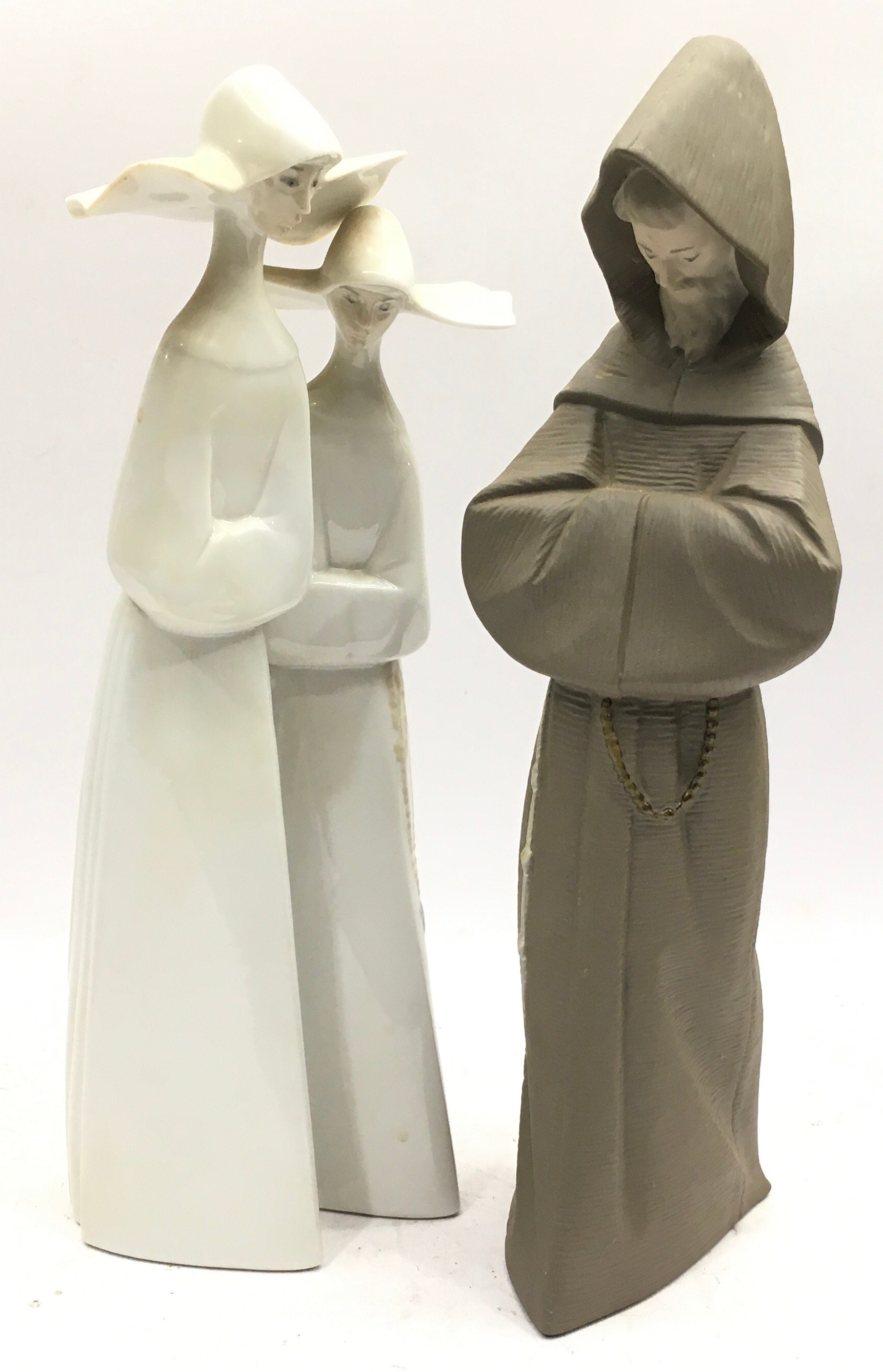 Two large Lladro figures, a gloss finish study of two nuns and a matt finish study of a hooded monk.