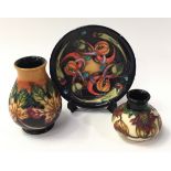 Moorcroft collection to include two small vases and a pin dish. Each piece signed, stamped and