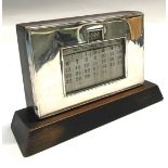 Silver frame on wooden base desk calendar