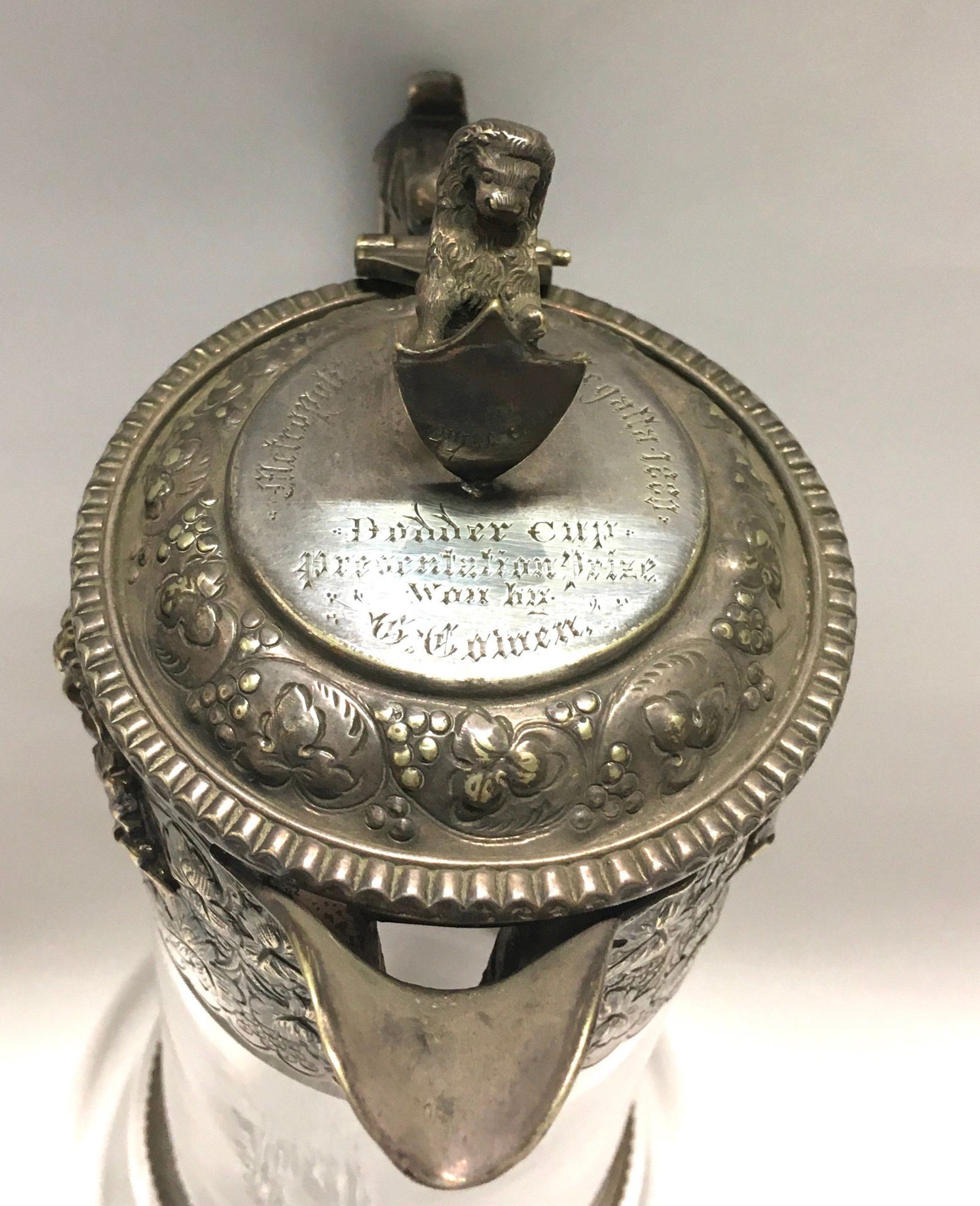 Vintage Claret jug with embossed decoration and Lion finial set as a trophy dated 1880 - Image 4 of 5