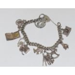 Silver charm bracelet and 10 charms 55g