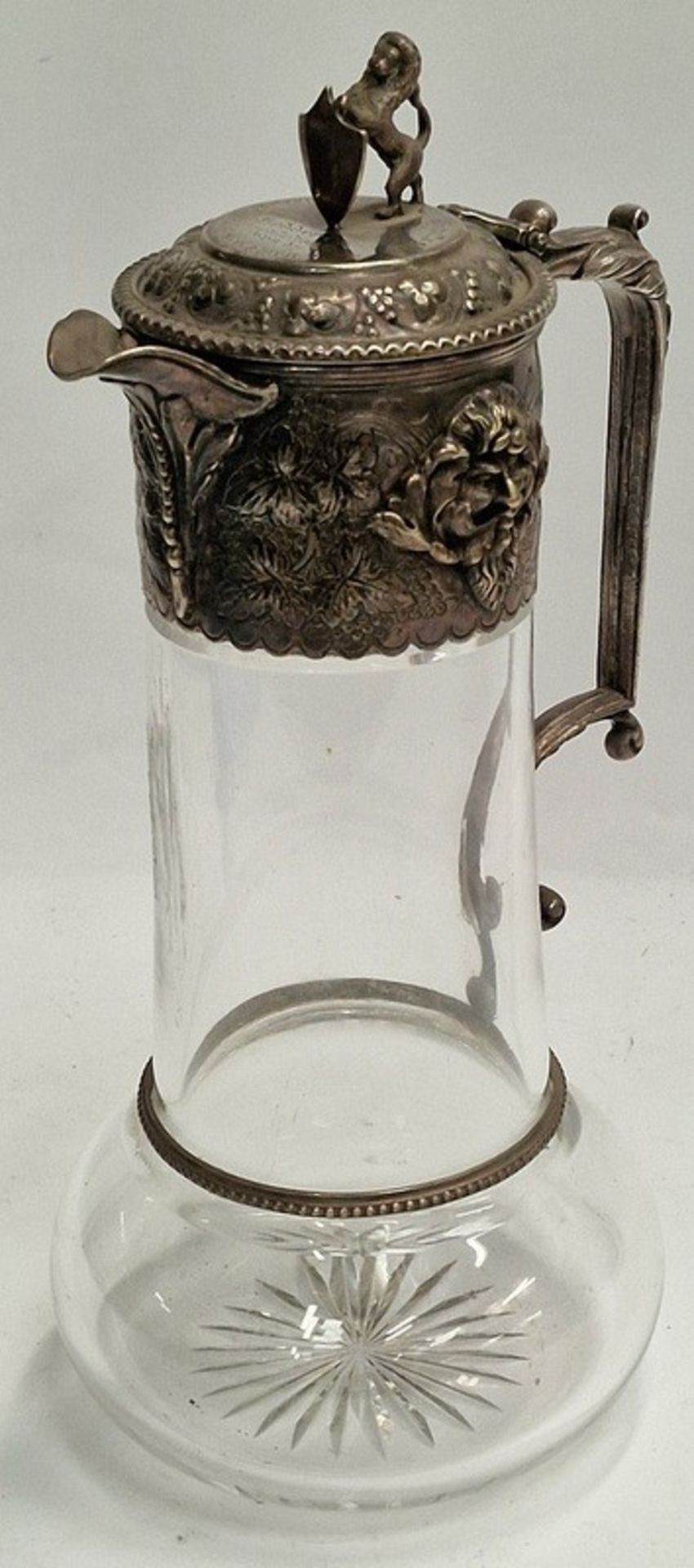 Vintage Claret jug with embossed decoration and Lion finial set as a trophy dated 1880