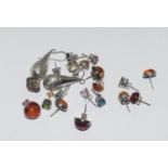 A bag of assorted pairs of silver earrings.