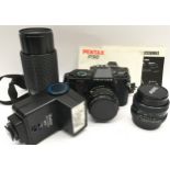 Vintage Pentax P30 35mm SLR camera c/w additional lenses and accessories. Complete in shoulder carry