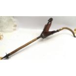 Vintage shooting stick with leather pouch seat and crossed rifles logo embossed to seat