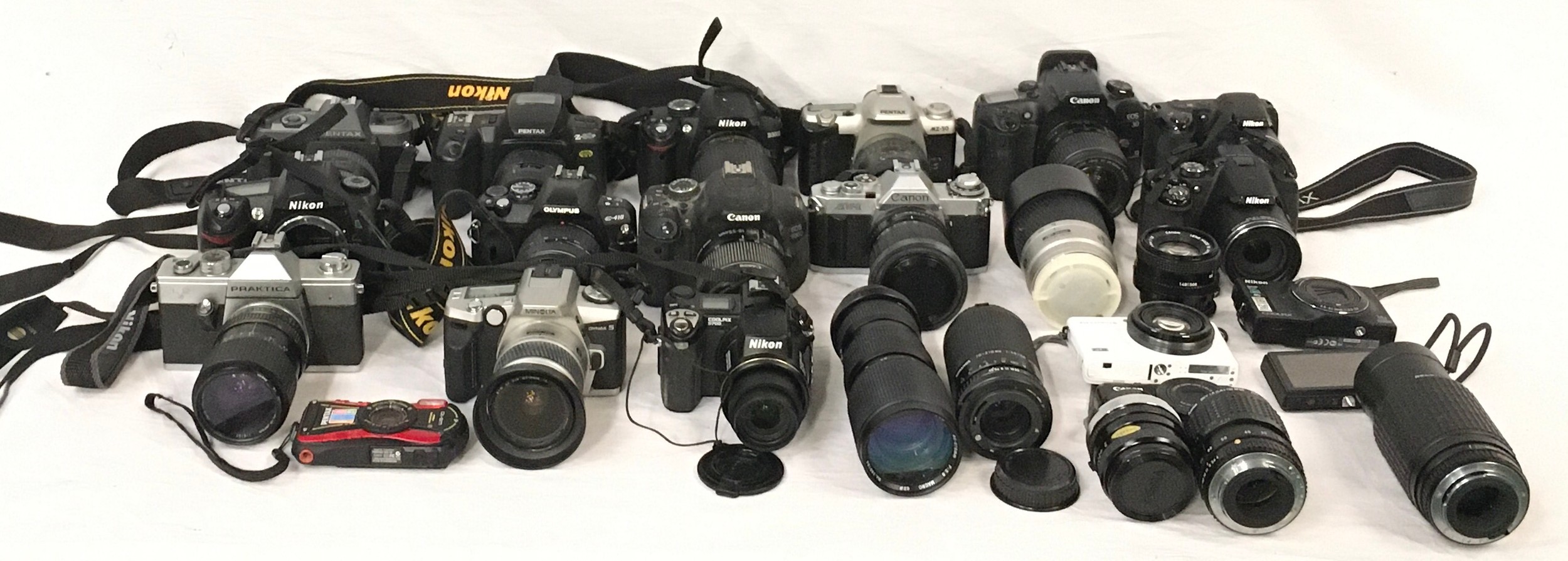 Very large collection of DSLR cameras and lenses to include examples by Nikon, Canon and Sony.