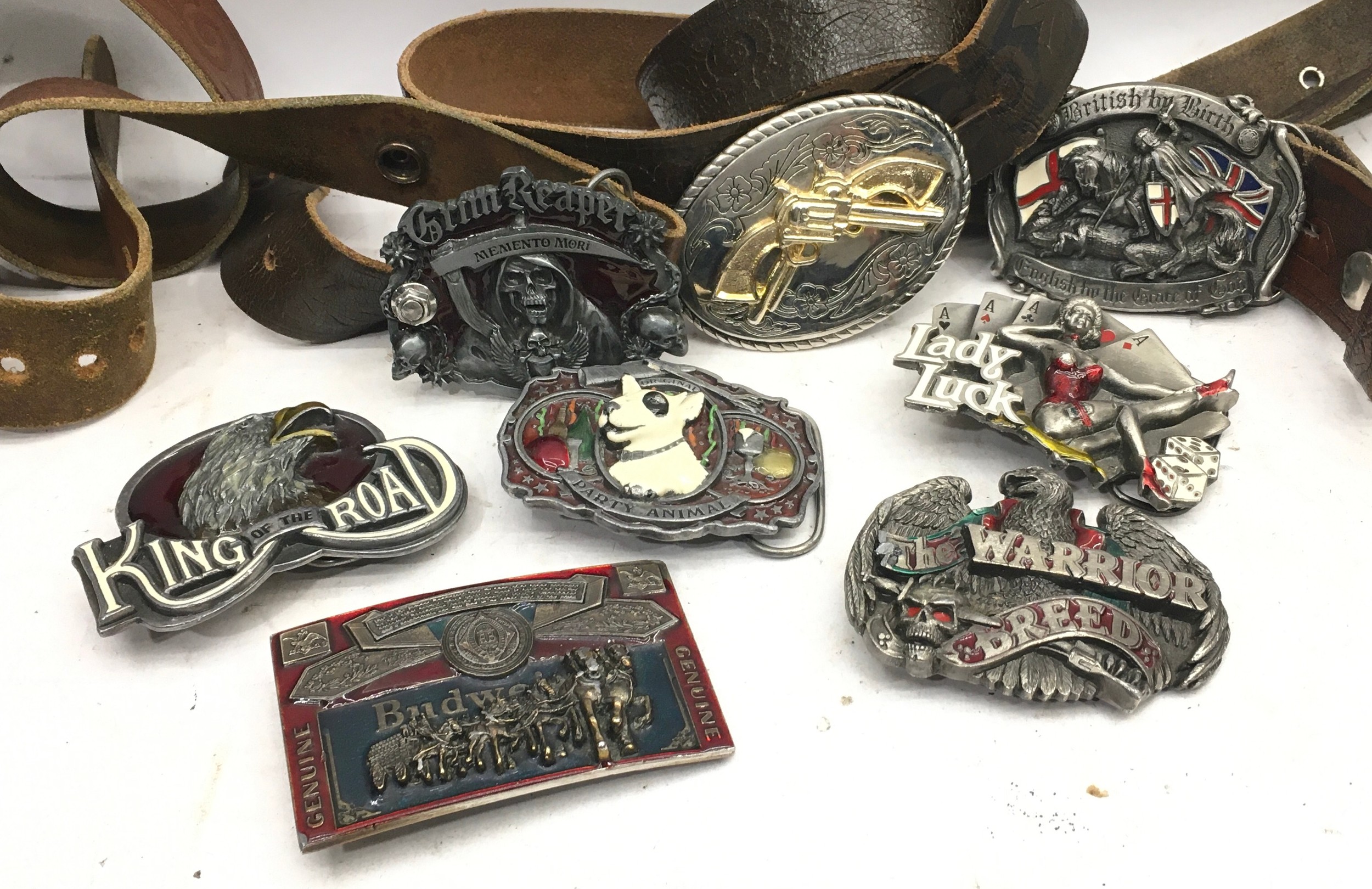 Quantity of leather belts and heavy cast metal belt buckles