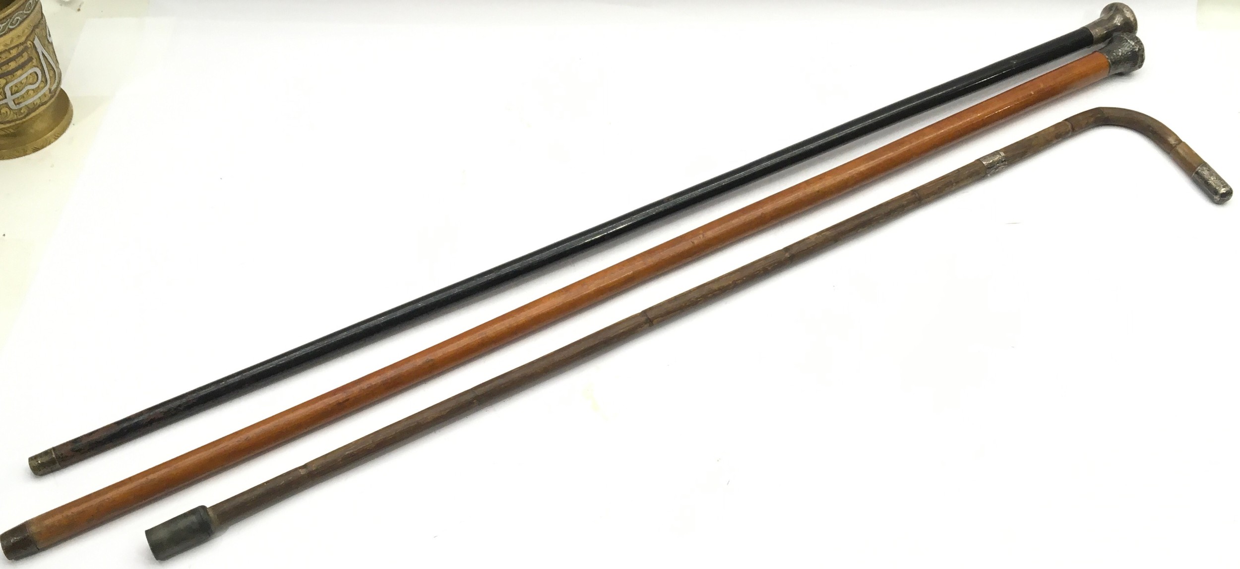 Collection of three silver topped walking canes