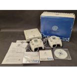 Sega Dreamcast vintage gaming console with leads and two controllers in original box.