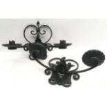 Pair of black painted cast metal wall sconces, each for 2 candles, indoor or outdoor use. 39cms