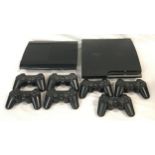 Two PlayStation 3 consoles with a large collection of controllers.