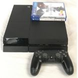 Sony PlayStation 4 console with a controller and two games.