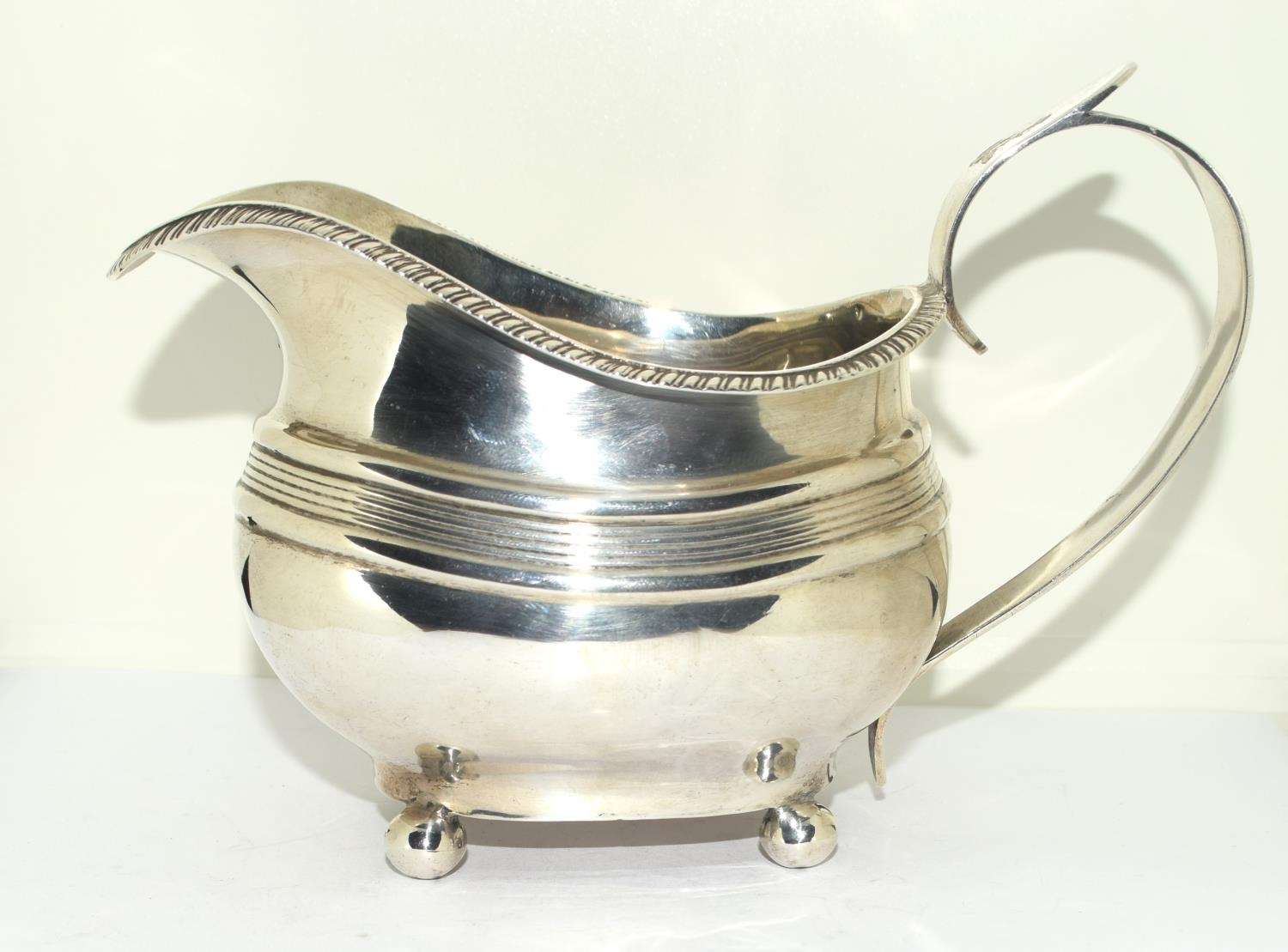 Georgian Silver oval cream jug on raised ball feet Exeter 1807