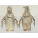 A pair of silver plated penguin condiments.