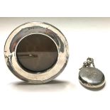 Silver H/M perfume bottle together a round silver easel back picture frame