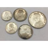 India 1885 Half Rupee c/w four further silver coins in very good condition