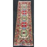 Persian/ Afgan long hall runner in red and green geometric pattern 204x67cm.