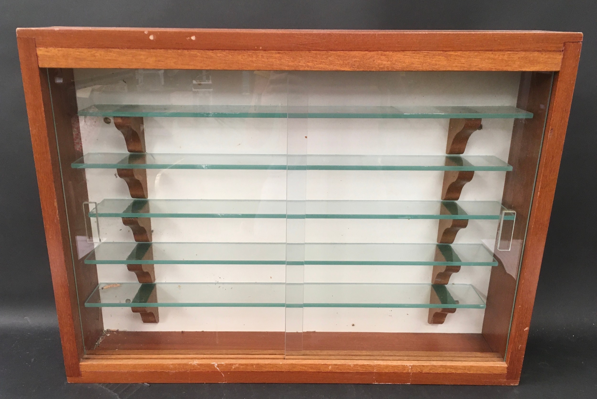 Glass fronted display case with 5 glass shelves. 61 x 46 x 11cms.