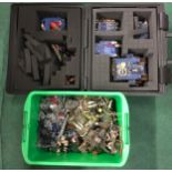 A collection of plastic Warhammer figures and a collectors case.