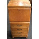 Art Deco oak veneer slim bureau by Joseph Serlin & Sons. With fitted interior over four drawers on