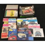 A box of vintage car brochures and adverts together with a box of vintage motorcycle brochures and