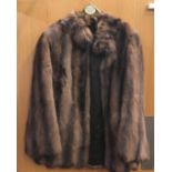 Two vintage short fur coats, one dark brown one cream