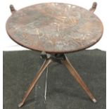 Small wooden tribal side table with folding base 54cm tall.