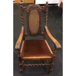Victorian Carolean style carved oak armchair with barley twist supports.