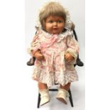Antique toy doll with miniature doll Windsor chair.