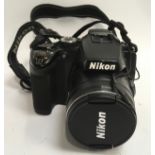 A Black Nikon CoolPix P500 digital camera. (127)