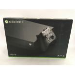 An Xbox One X, boxed including controller and 4 games. (19)