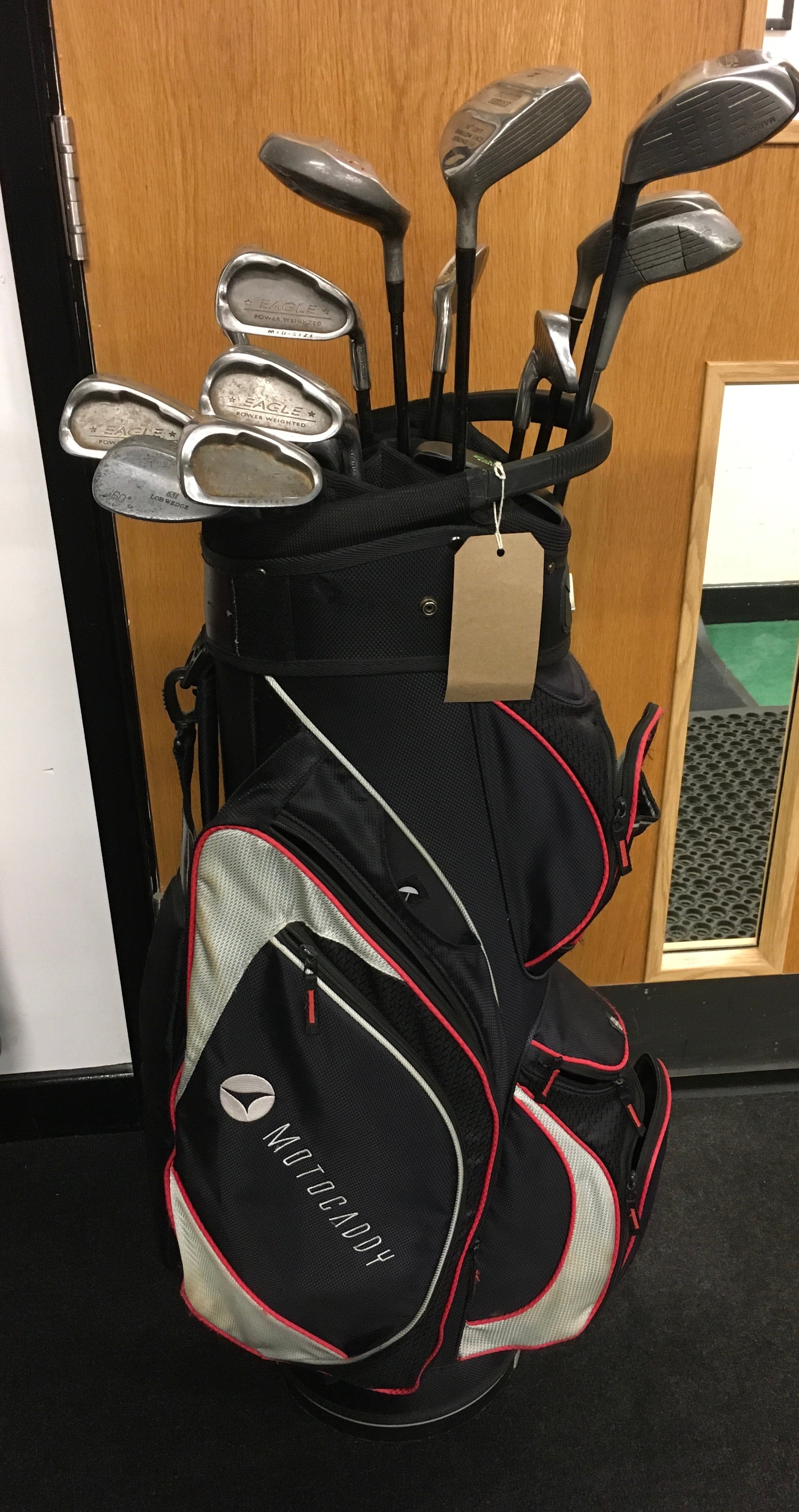 A set of golf clubs in motorcaddy bag. (74) (12)