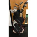 A set of golf clubs in motorcaddy bag. (74) (12)