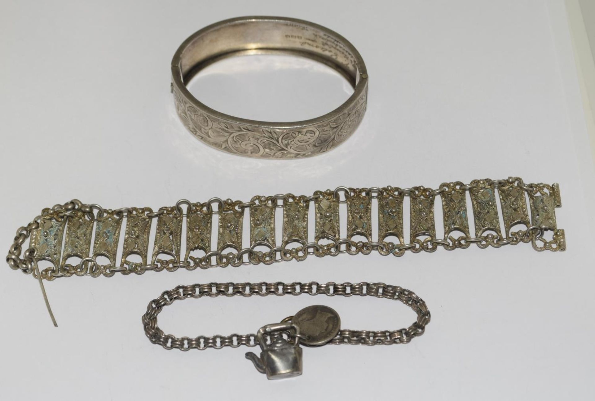 Three antique silver and metal bracelets/bangles.