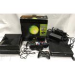 Xbox consoles with controllers and power supplies.