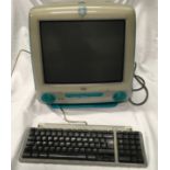 Apple IMac blue with keyboard and mouse.