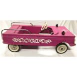 Vintage Astra tin pedal car in pink.