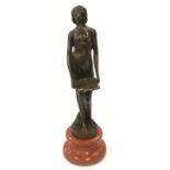 A bronze female figure on marble base.