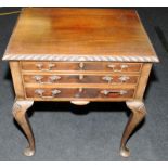 Three drawer mahogany cabinet with shell motif on cabriole legs containing an extensive and complete
