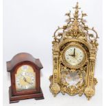 Two mantel clocks, a heavy gilded cast metal quartz example and a wooden mechanical striking