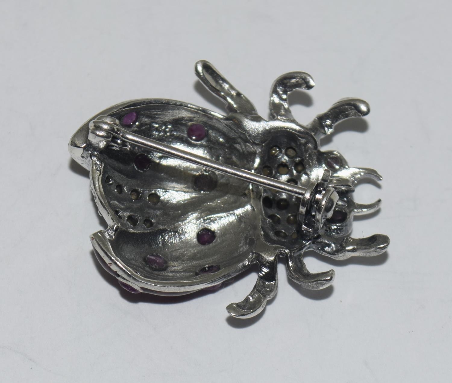 A silver enamel lady bird brooch set with ruby eyes. - Image 3 of 3