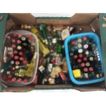 Crate containing many miniature bottles of various alcoholic drinks.