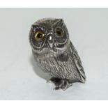 A Silver wise owl figure with glass eyes.