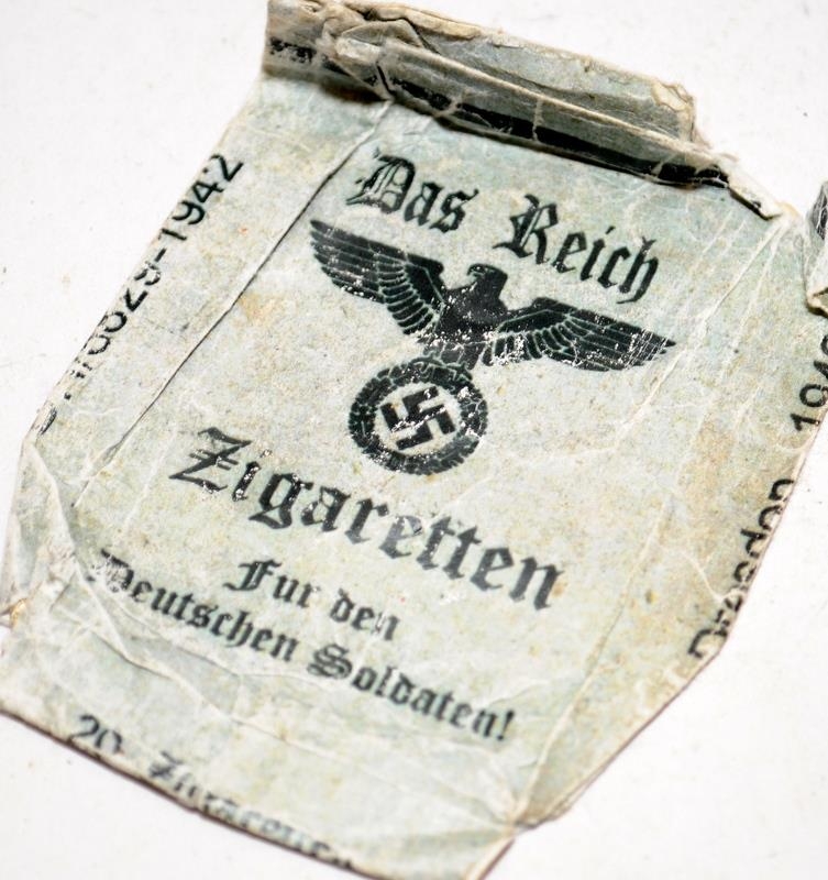 WW2 German 1939 Iron Cross medal with crossed swards c/w a Das Reich Zigaretten cigarette packet. - Image 3 of 3
