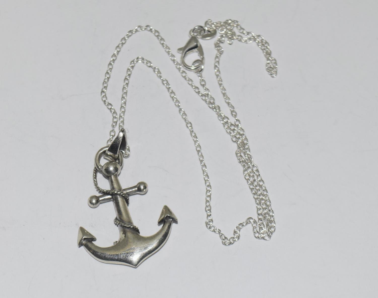 A silver anchor pendant necklace on silver chain