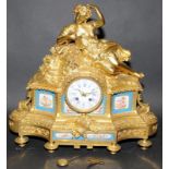 Ornate gilded French striking mantel clock with hand painted porcelain panels signed to reverse.
