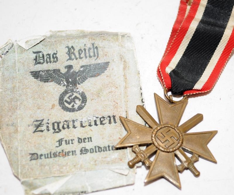 WW2 German 1939 Iron Cross medal with crossed swards c/w a Das Reich Zigaretten cigarette packet.