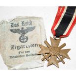 WW2 German 1939 Iron Cross medal with crossed swards c/w a Das Reich Zigaretten cigarette packet.